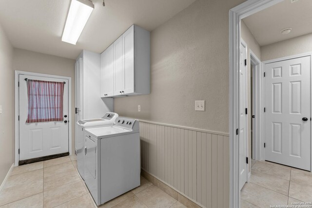 1300 Windmill Dr, La Vernia, TX 78121 - washroom featuring a wainscoted wall, light tile patterned floors, cabinet space, and independent washer and dryer