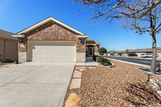 single story home featuring a garage, stone siding, concrete driveway, and brick siding