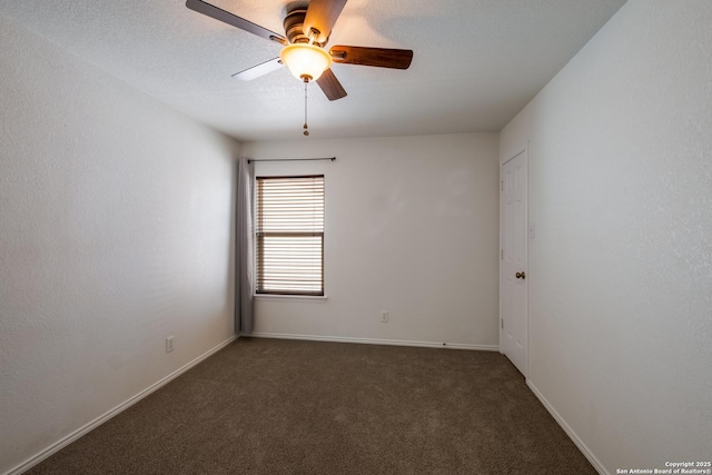 empty room with a textured ceiling, carpet, a ceiling fan, and baseboards