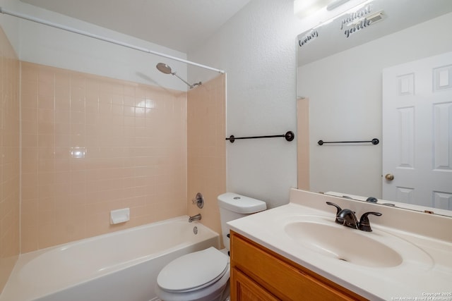 bathroom with toilet, shower / tub combination, and vanity