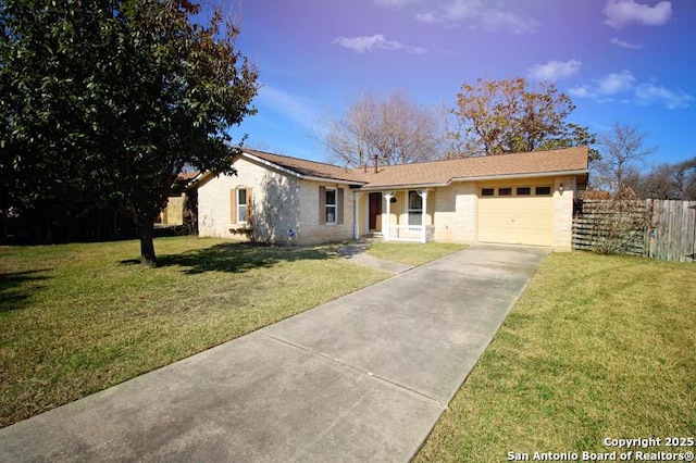 ranch-style home featuring an attached garage, driveway, a front yard, and fence