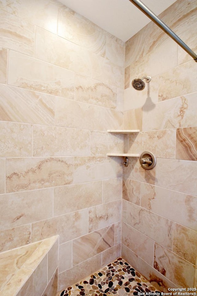 bathroom with a tile shower