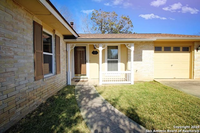 entrance to property featuring a garage, concrete driveway, a lawn, a porch, and brick siding