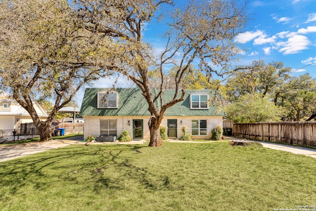 view of front facade featuring brick siding, a front yard, fence, and central air condition unit