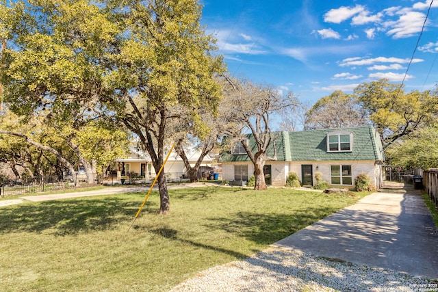 view of front of property with fence and a front lawn