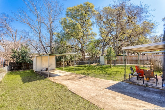 view of yard featuring a storage shed, a fenced backyard, an outbuilding, and a patio