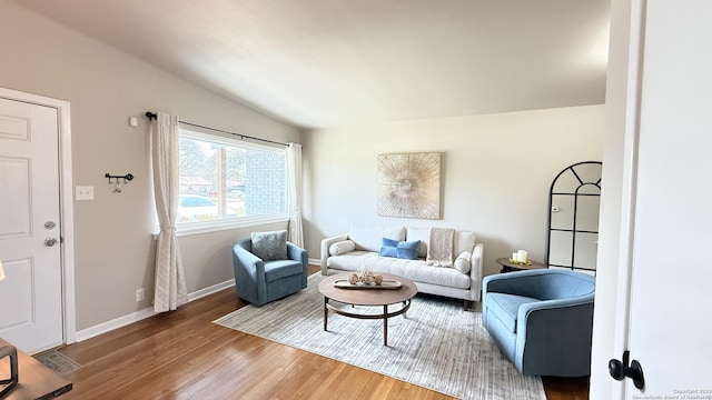 living room with baseboards and wood finished floors