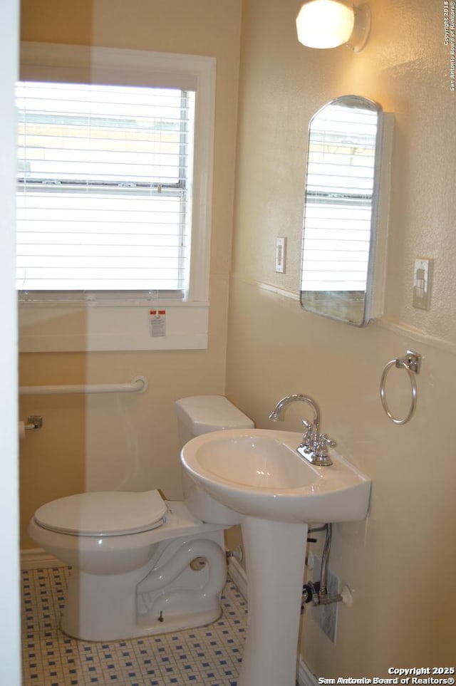 bathroom featuring toilet and tile patterned floors