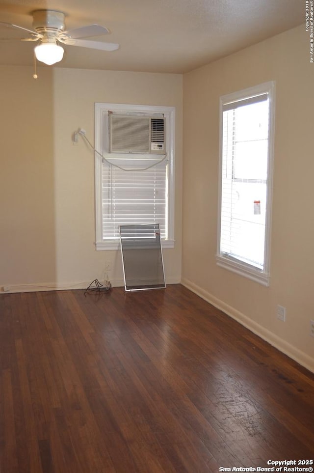 unfurnished room with ceiling fan, wood-type flooring, a wall mounted air conditioner, and baseboards