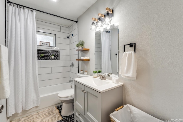 full bath featuring toilet, a textured wall, vanity, and shower / tub combo with curtain