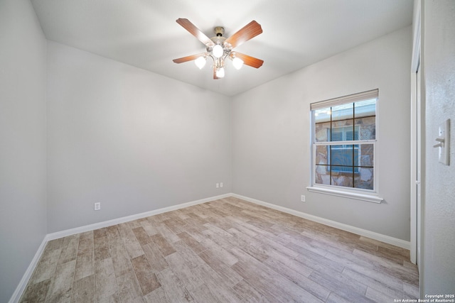 empty room with baseboards, a ceiling fan, and wood finished floors