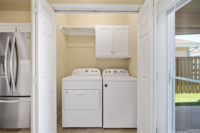 laundry room featuring cabinet space and separate washer and dryer