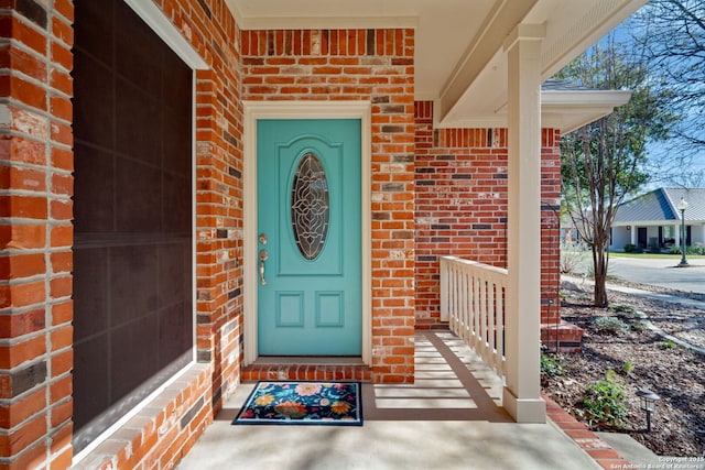 property entrance with brick siding