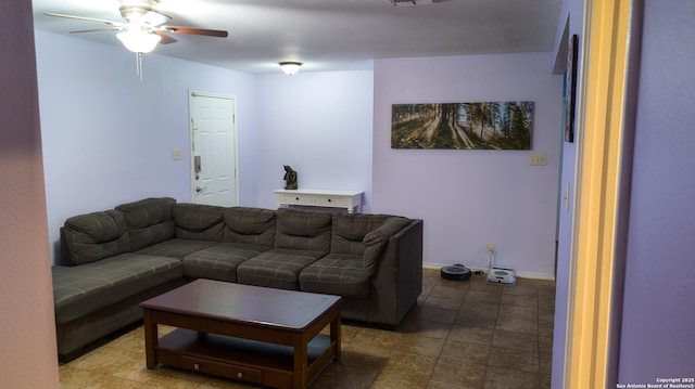 living area featuring ceiling fan and baseboards