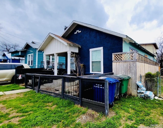 rear view of property featuring fence