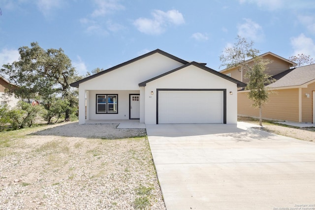 single story home with driveway, an attached garage, and stucco siding