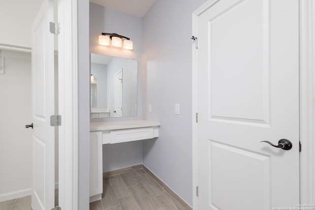 bathroom with vanity and baseboards