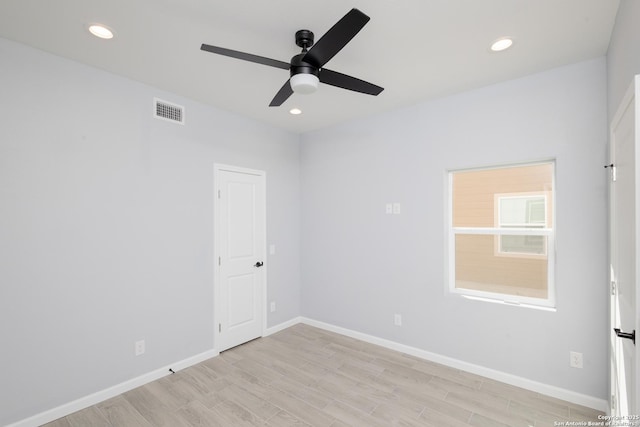 unfurnished room with light wood-style floors, visible vents, baseboards, and recessed lighting