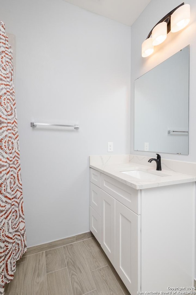 bathroom featuring vanity and baseboards