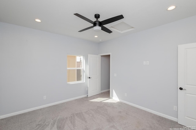 empty room with baseboards, recessed lighting, attic access, and light colored carpet