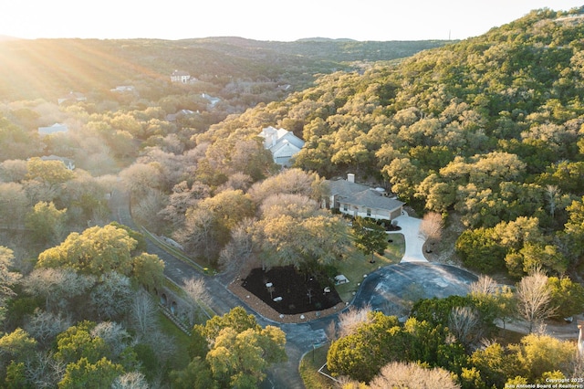 drone / aerial view featuring a forest view