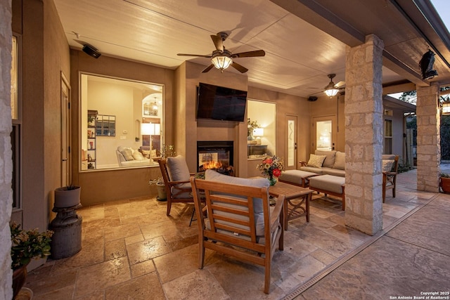 exterior space featuring ceiling fan and an outdoor hangout area