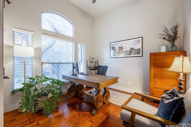 home office with wood-type flooring, baseboards, vaulted ceiling, and a ceiling fan