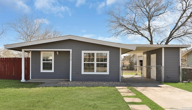 exterior space featuring central AC, fence, driveway, a gate, and a front yard