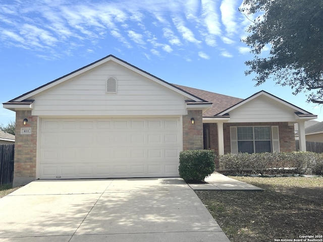 single story home with driveway, brick siding, and an attached garage