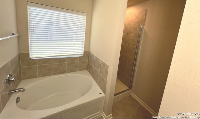 full bath featuring tile patterned flooring, a shower stall, and a bath