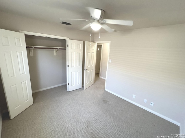 unfurnished bedroom with carpet floors, baseboards, visible vents, and a closet