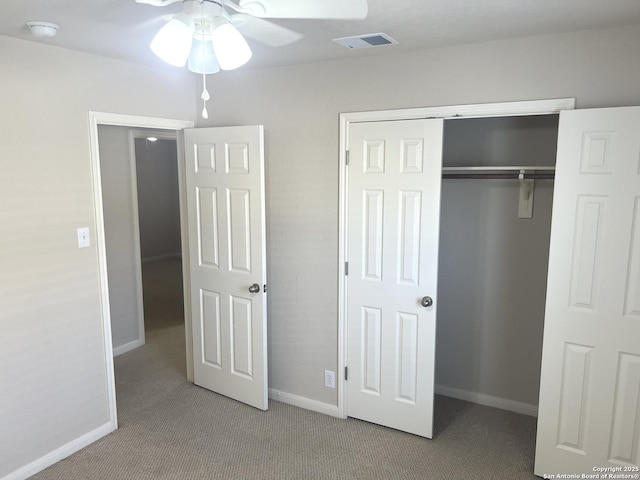 unfurnished bedroom featuring carpet, a closet, visible vents, and baseboards