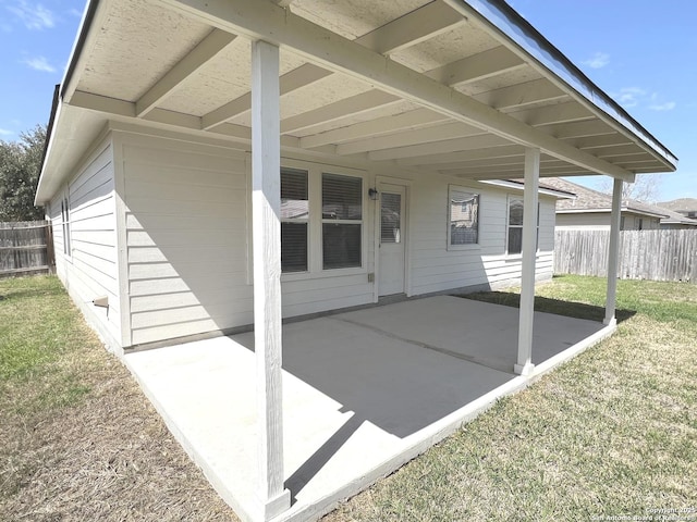 view of patio / terrace with a carport and fence