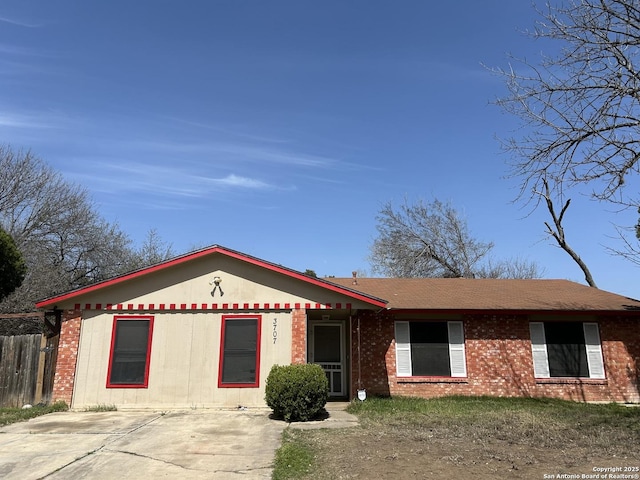 single story home with fence and brick siding