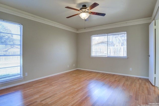 unfurnished room with ceiling fan, baseboards, light wood-style flooring, and crown molding