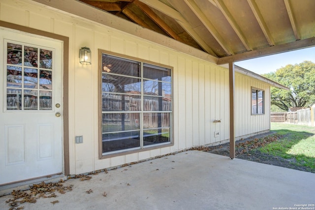 property entrance with a patio area and fence