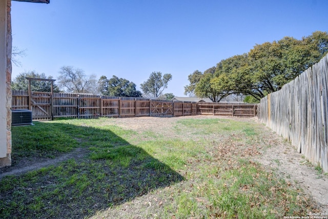 view of yard featuring central AC and a fenced backyard