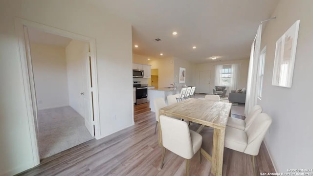 dining space featuring light wood-type flooring, visible vents, and recessed lighting