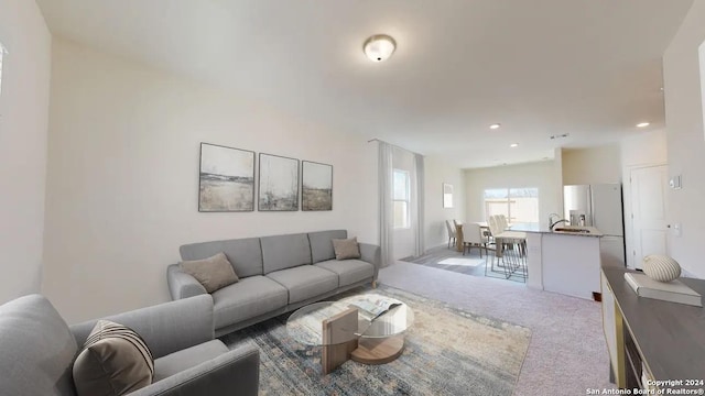 carpeted living area featuring recessed lighting