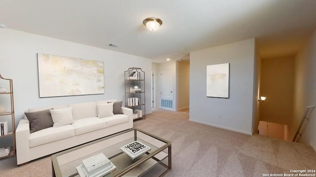 living area with carpet, visible vents, and baseboards