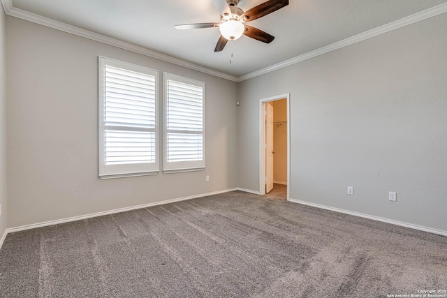 empty room featuring ceiling fan, ornamental molding, carpet flooring, and baseboards