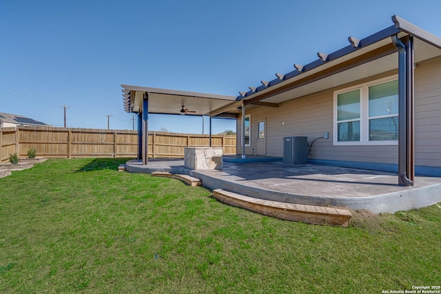 view of yard featuring central AC unit, a patio area, and fence