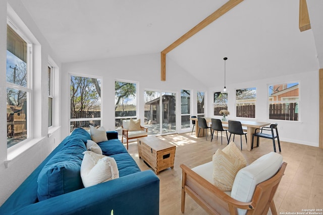 living room featuring high vaulted ceiling, beamed ceiling, light wood-style flooring, and baseboards