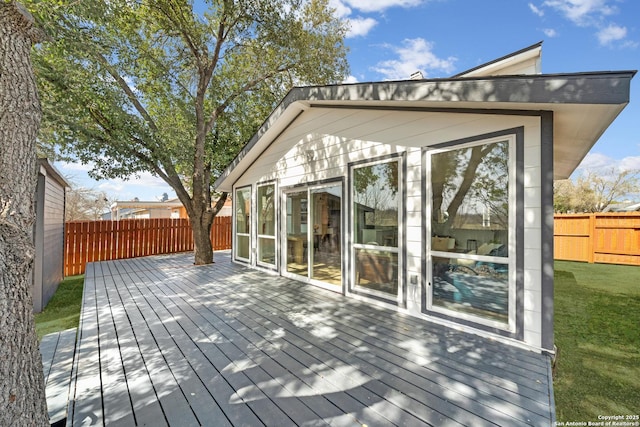 deck featuring a lawn and a fenced backyard