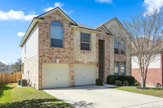 traditional home with an attached garage, brick siding, fence, concrete driveway, and a front yard