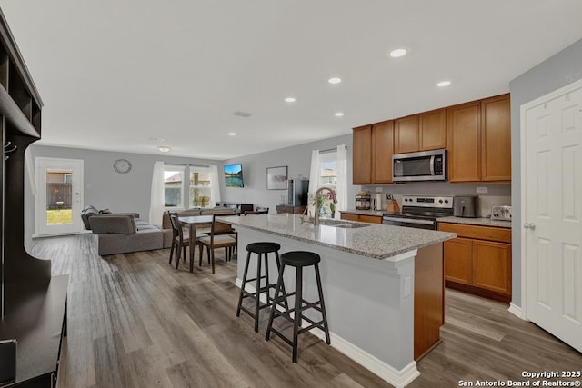 417 Briarfield, Seguin, TX 78155 - kitchen with a center island with sink, a sink, wood finished floors, open floor plan, and stainless steel appliances