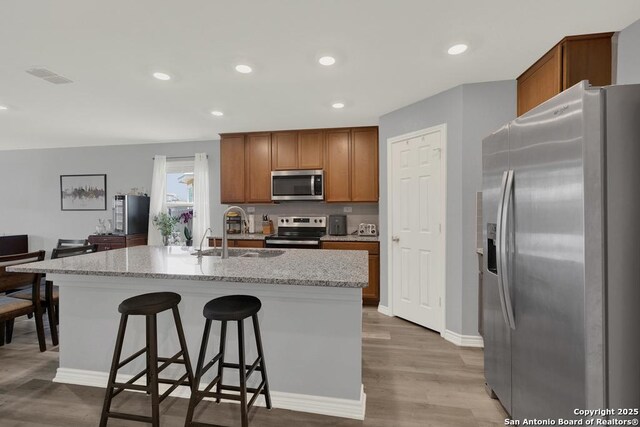 417 Briarfield, Seguin, TX 78155 - kitchen with wood finished floors, visible vents, a sink, stainless steel appliances, and a kitchen breakfast bar