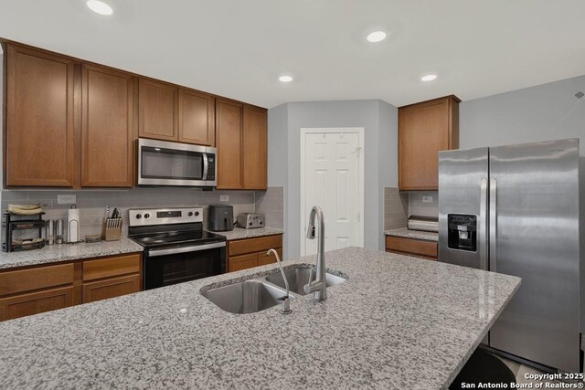 417 Briarfield, Seguin, TX 78155 - kitchen featuring a sink, stainless steel appliances, and brown cabinetry