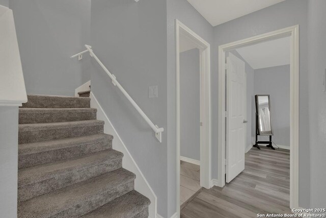 417 Briarfield, Seguin, TX 78155 - stairs featuring baseboards and wood finished floors