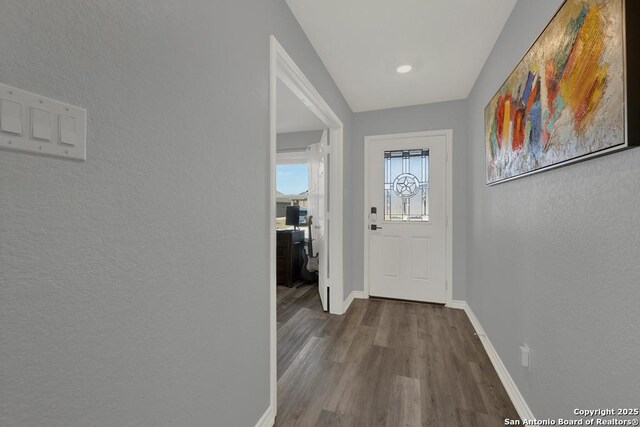 417 Briarfield, Seguin, TX 78155 - doorway to outside featuring baseboards and wood finished floors